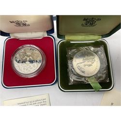 Seven The Royal Mint United Kingdom sterling silver proof crown coins, comprising two 1972, three 1977, 1981 and 1993, all cased with certificates and a Queen Elizabeth II 2001 one ounce fine silver Britannia coin on card (8)