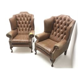 Pair Queen Anne style wingback armchairs upholstered in a deep buttoned studded tan leather, cabriole legs