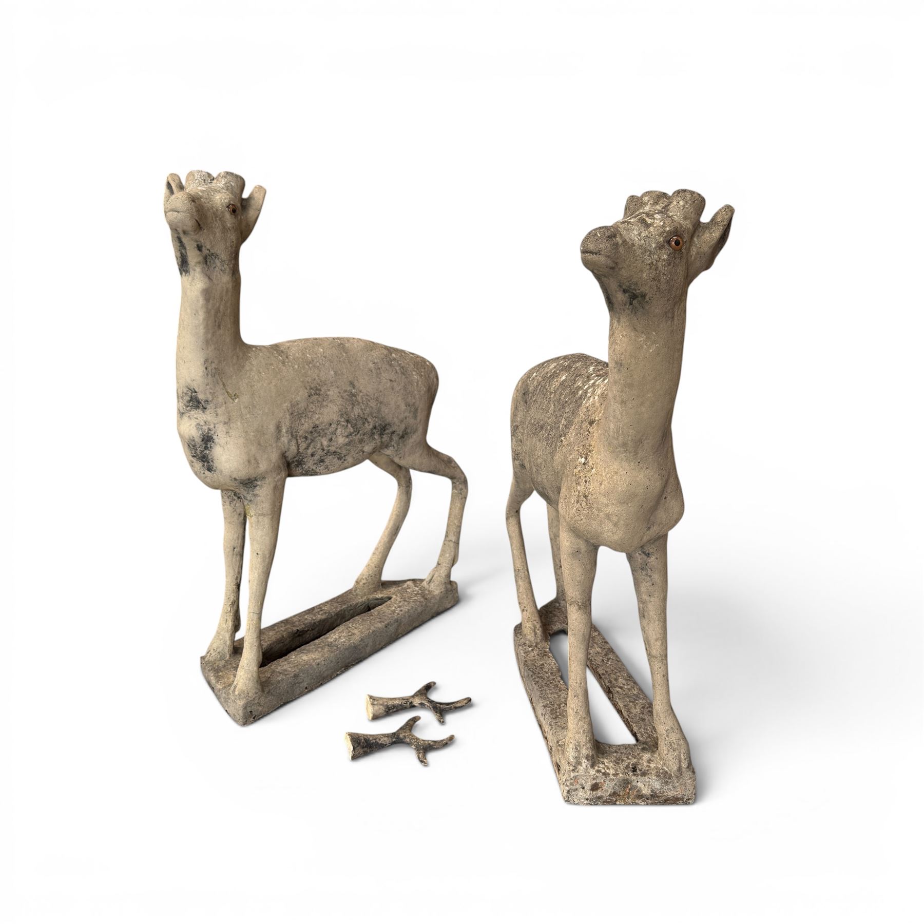 Pair of cast stone garden deer in a weathered finish with two loose antlers