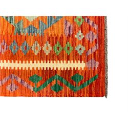 Anatolian Turkish Kilim amber ground rug, the field decorated with four lozenges with ivory outline, the double banded orange border with repeating geometric patterns 