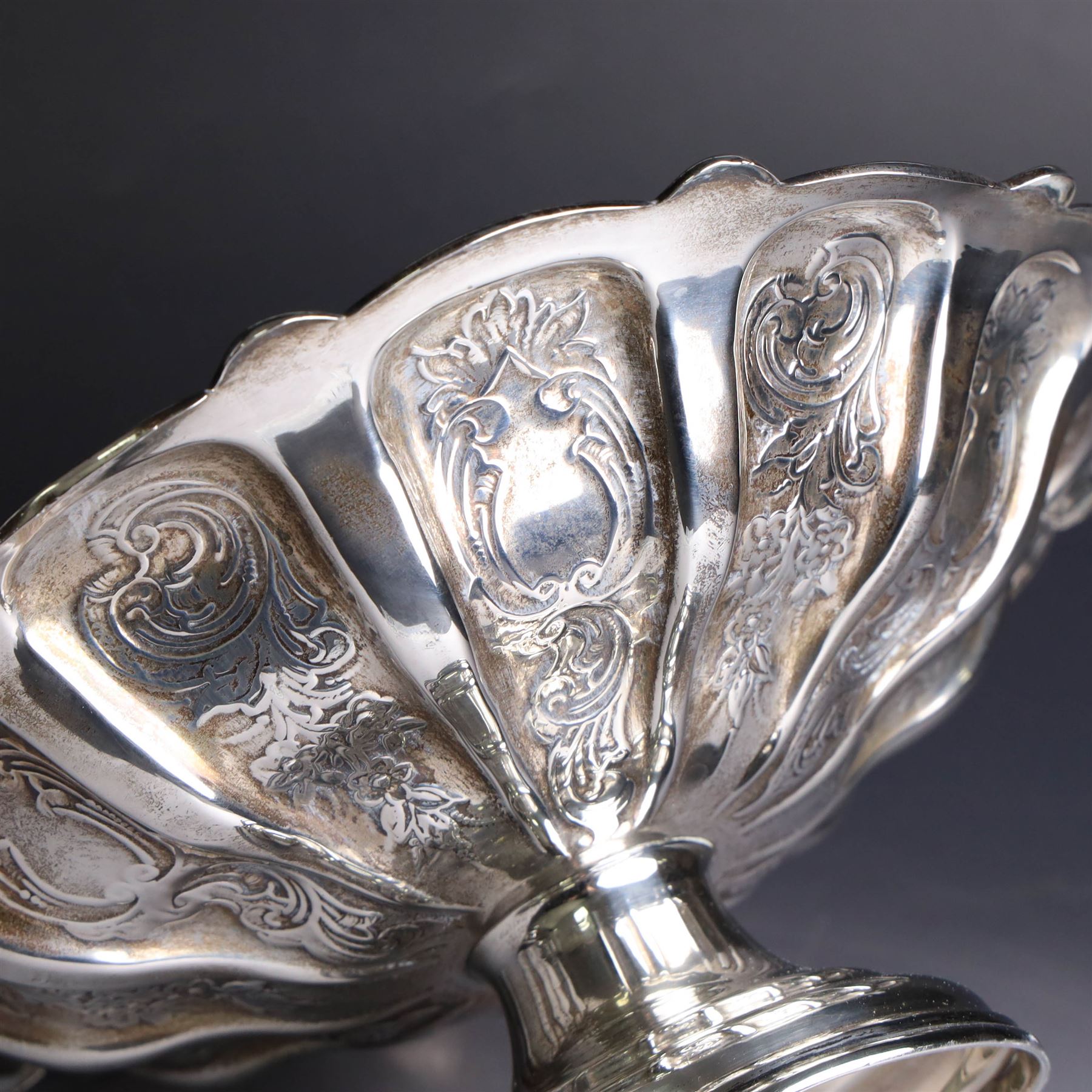 Edwardian silver swing handled basket, of circular form with shaped rim and engraved floral and foliate decoration, with know design swing handle and upon circular stepped pedestal, hallmarked J Sherwood & Sons, Birmingham 1901, H9cm, D22cm