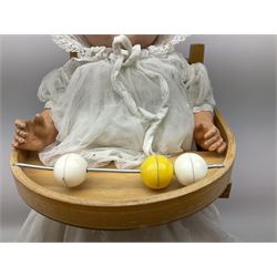 Armand Marseille composition head doll with moulded hair, sleeping eyes, open mouth with teeth and composition body with jointed limbs, marked 'AM Germany' H55cm; together with doll's beech high-cum-low chair with abacus (2)