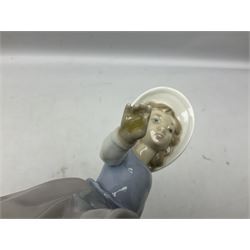 Three Nao figures comprising The Next Dance 1201 and Girls First Communion 0236, and young girl wearing a hat, together with two further Spanish style figures