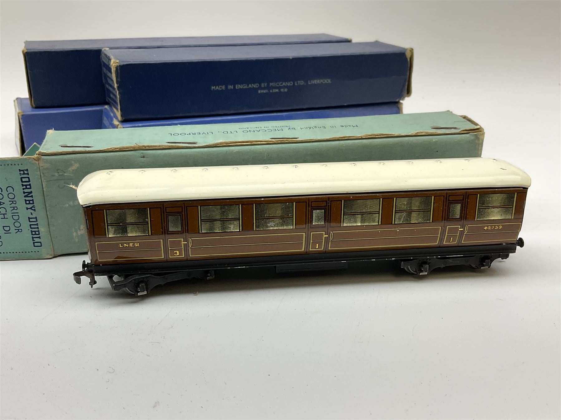 Hornby Dublo - two D1 LNER Corridor Coaches comprising First/Third, in pale blue box and Third in medium blue box; two D11 BR/ER Corridor Coaches First/Third and Brake/Third, in medium and dark blue boxes; and D12 BR/LMR First/Third Corridor Coach in dark blue box (5)