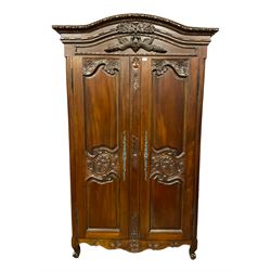 French style mahogany double wardrobe, shaped pediment carved with flower heads and bird mount, enclosed by two panelled doors with floral decoration, scrolled feet