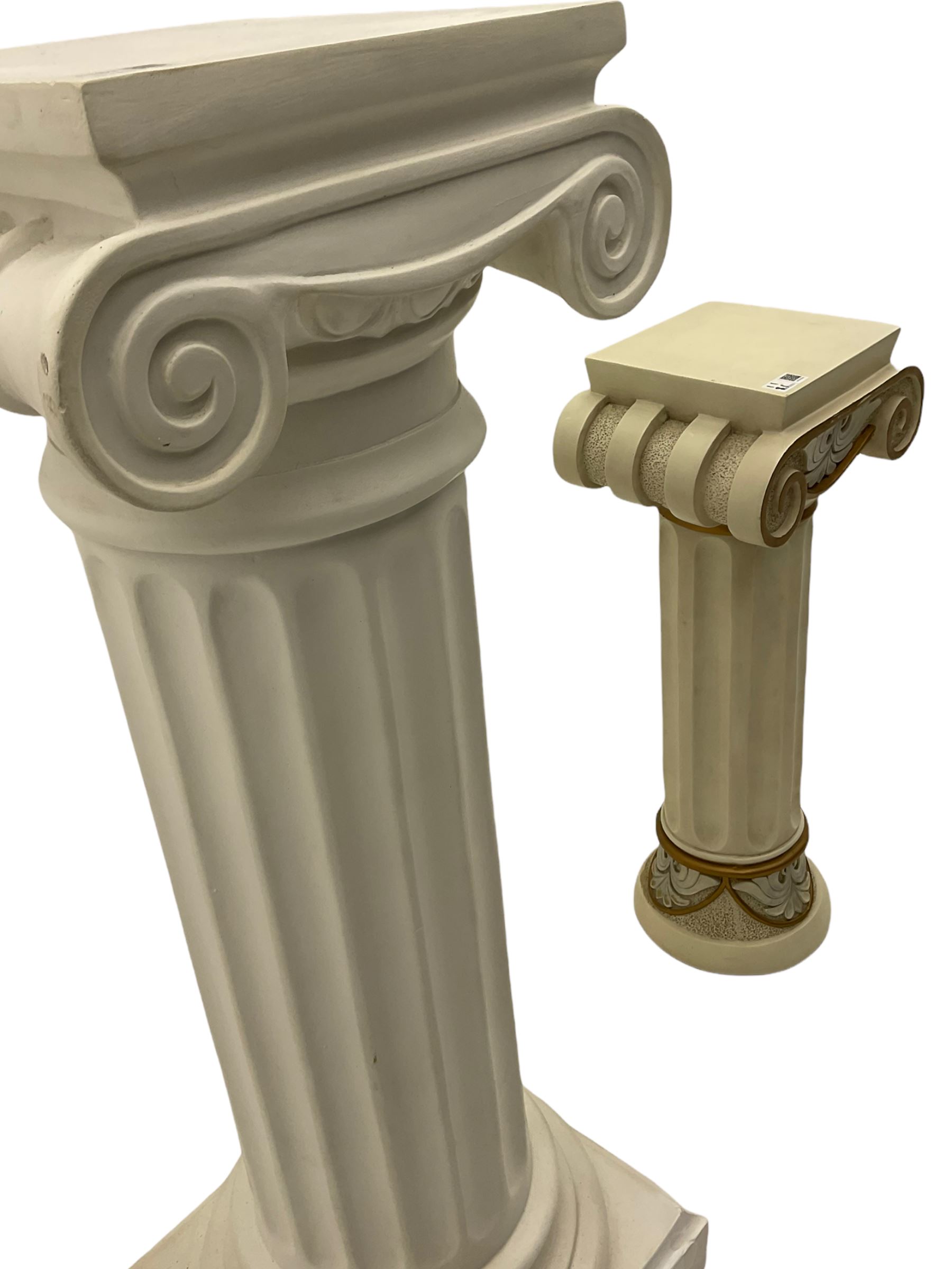 Classical Ionic style column in white finish with scrolled capital, fluted body on moulded plinth base (H97cm), and a similar small column stand (H68cm)