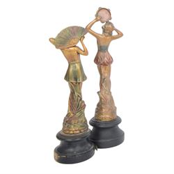 Four Art Deco style figures, modelled as dancers in various poses, finished in gilt and upon wooden plinths, H33cm