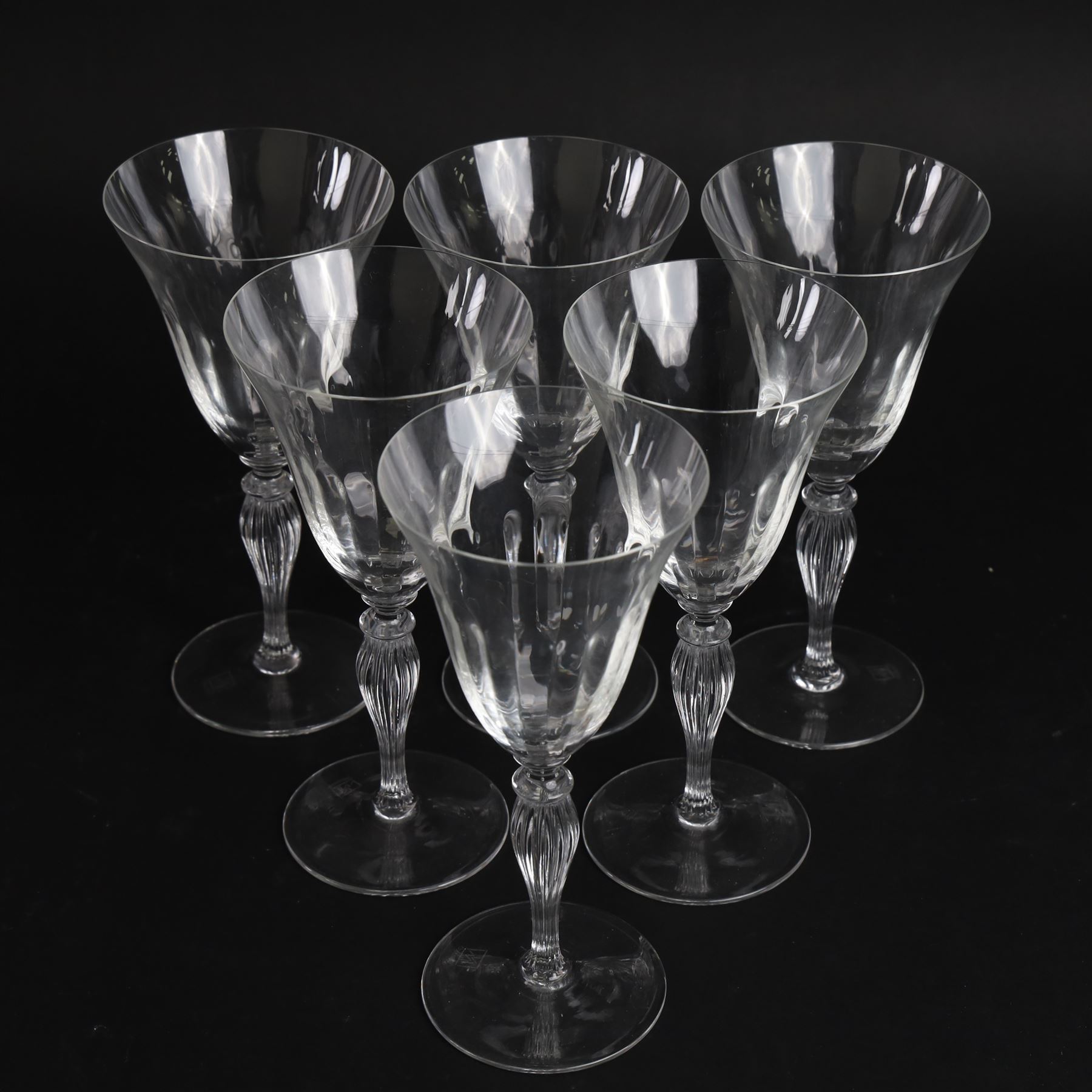 Set of six Murano clear glass wine glasses, each with part moulded fluted flared bowl, upon a knopped and fluted baluster stem and spreading circular foot, with etched marks beneath, H19.5cm
