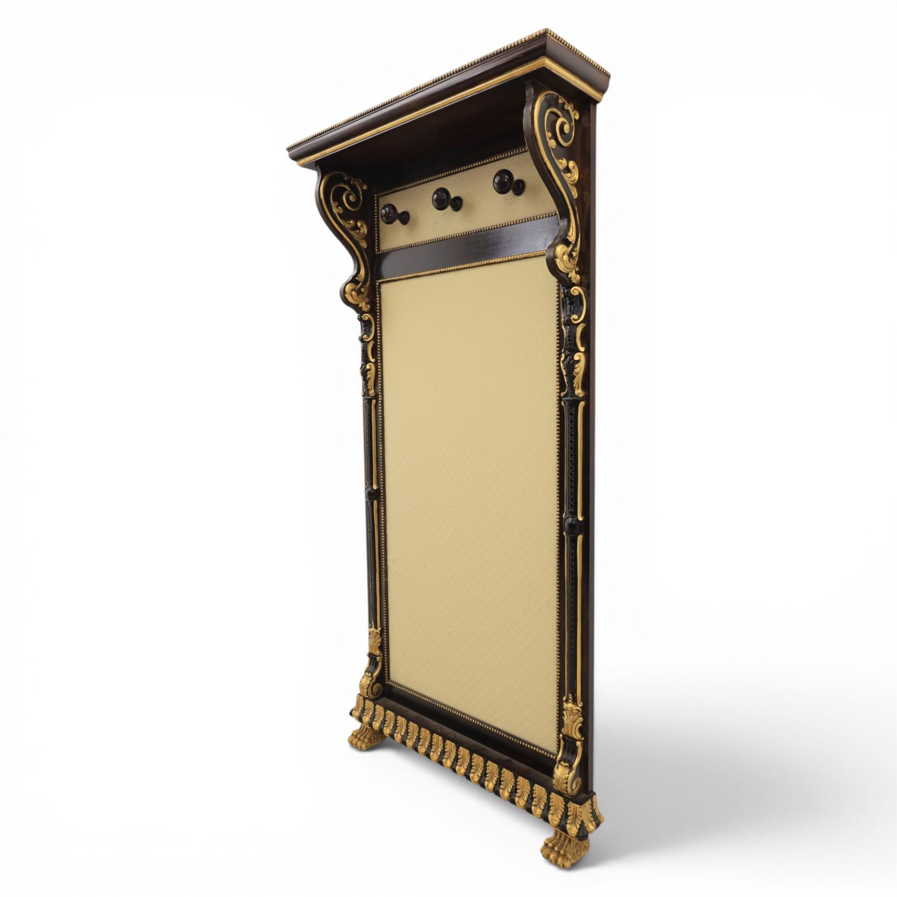 Empire design ebonised and parcel gilt hall stand, projecting moulded cornice with bead and reel border, upper rail fitted with three turned hat and coat pegs, central cream upholstered panel within beaded slip, flanked by scrolled uprights with gilt foliate and anthemion mounts, lower acanthus leaf apron, on paw feet