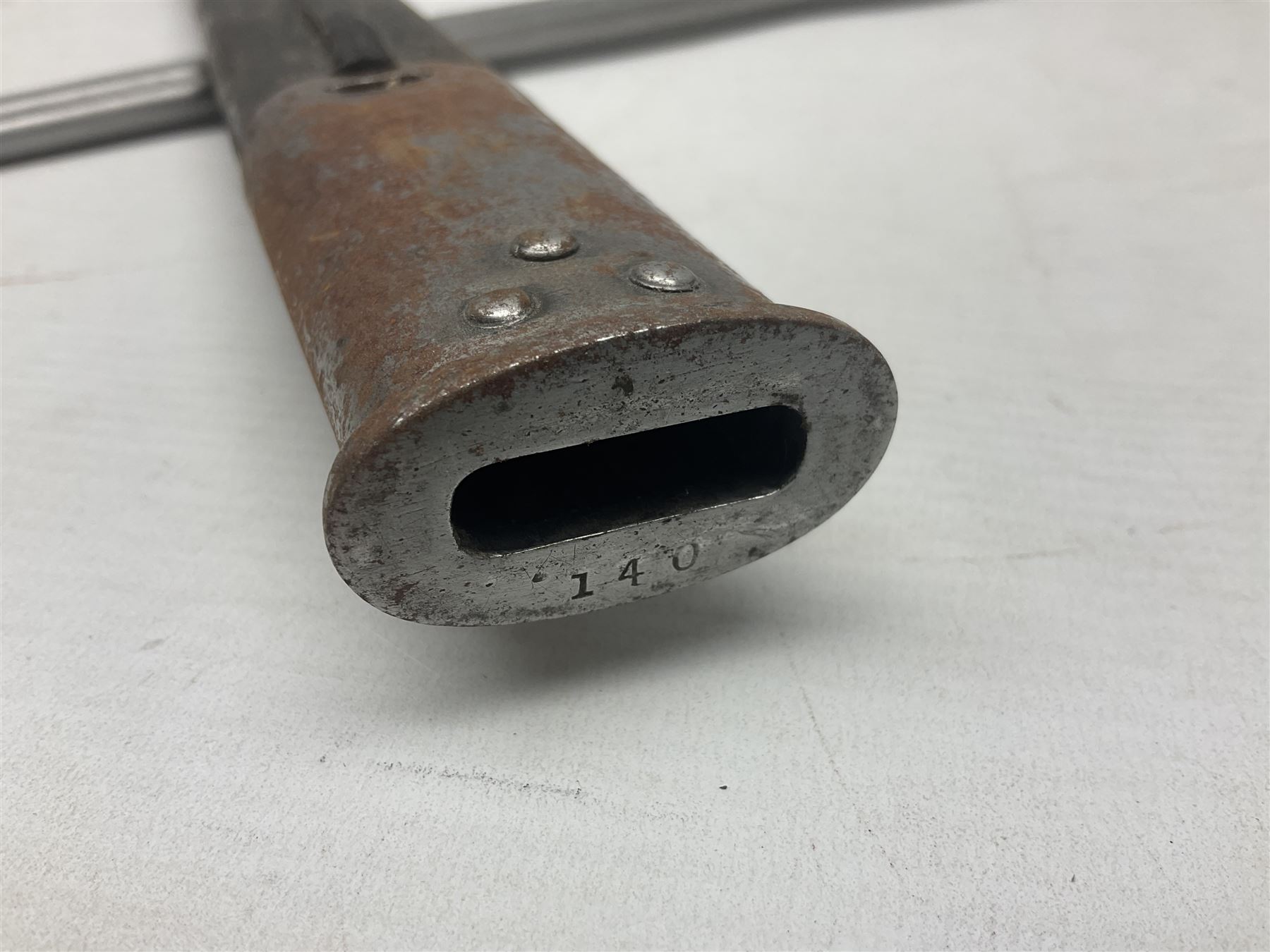 WW1 British 1907 pattern bayonet, the 43cm single edged fullered blade stamped to the ricasso with a crown GR cypher 1907 8 15 Sanderson, with various ordnance marks verso, two piece walnut grip, pommel stamped 1HLI 354; in steel mounted leather scabbard stamped 140 to the throat L57cm overall