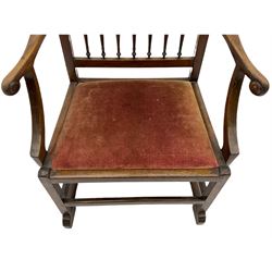 Late 18th century walnut 'Drunkard's' chair, the shaped and pierced cresting rail over spindle back, wide drop in upholstered seat, the arm terminals carved with roundels, on sledge supports with bracket feet, joined by stretchers