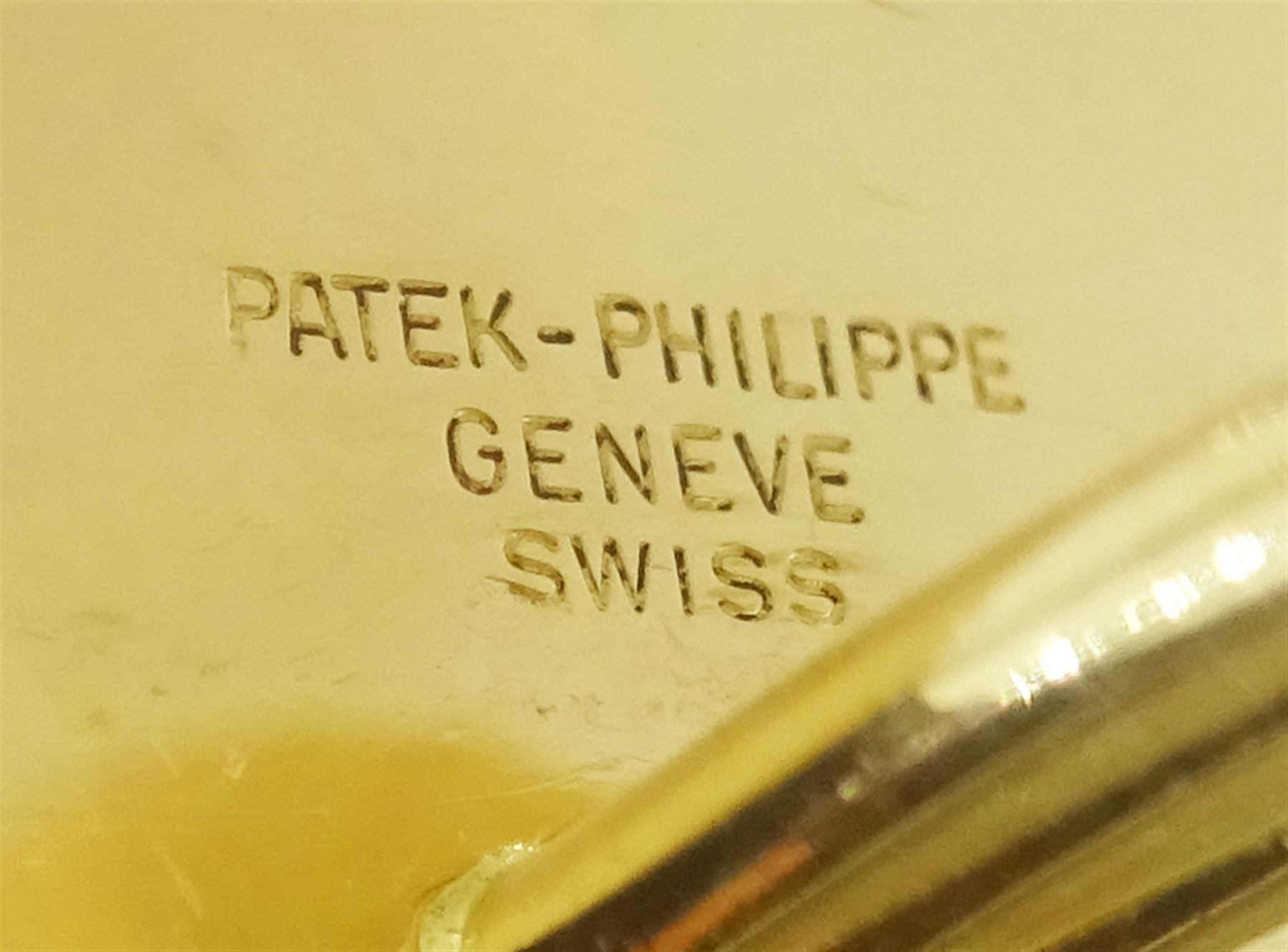 Pair of Patek Philippe Nautilus 18ct yellow gold and diamond cufflinks, with sapphire crystal, black-grey centre and diamond-set front, hallmarked, in original box