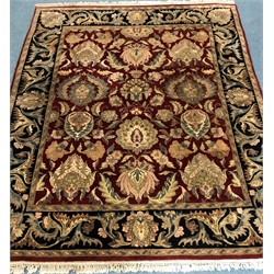Persian style red ground rug, central field of stylised motifs, repeating border,  310cm x 250cm
