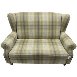 Next Home - two-seat hardwood framed wingback sofa, upholstered in pale green checkered fabric, on turned front feet