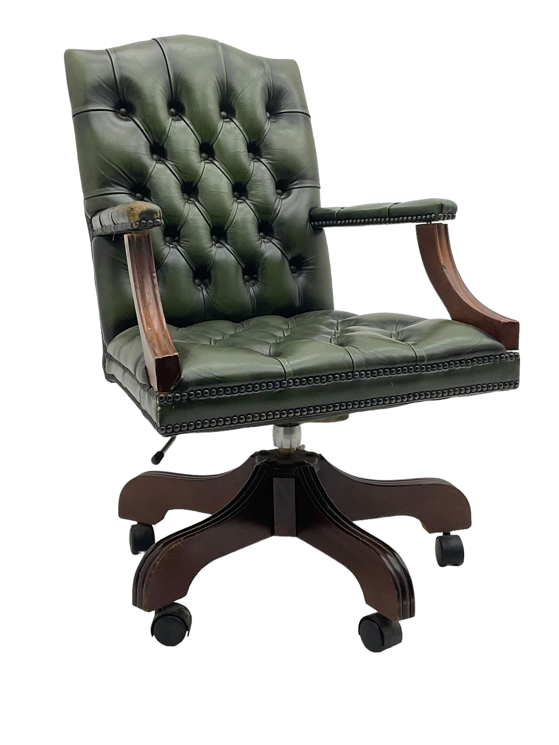 Georgian design swivel office desk chair, upholstered in buttoned green leather, on five spoke base with castors 