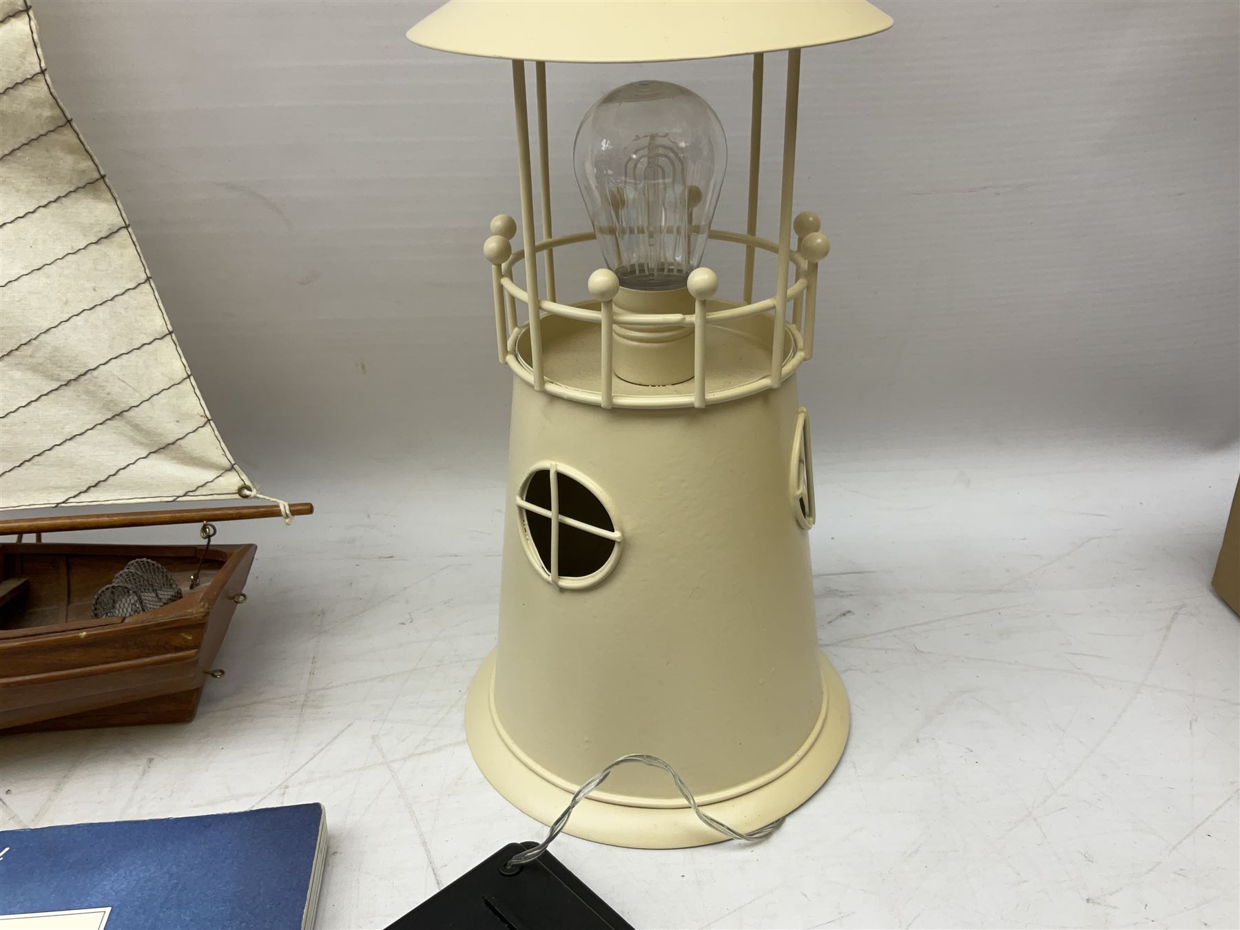 Nautical themed decorative items, to include Titanic book ends, model boat, books, lighthouse lamp etc in one box