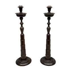 Pair of turned wooden candlesticks, the 