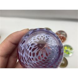 Collection of glass paperweights, to includes examples with internal air bubble inclusions and ones with internal flowers (11)