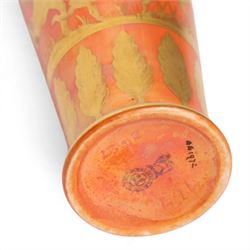 Royal Doulton orange lustre vase, decorated  with gilt figure hunting a stag, above a  boarder of trees, H14cm