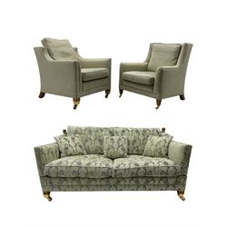 Three-piece hardwood-framed lounge suite - large two-seat Knole sofa with drop ends, upholstered in patterned fabric decorated with urns and foliage (W190cm, D117cm, H88cm); armchair upholstered in contrasting geometric pattern fabric (W83cm, D102cm, H93cm); and another armchair (W82cm, D102cm, H92cm) (3)