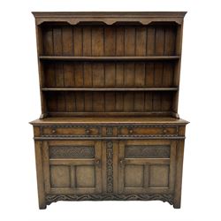 20th century Jacobean style carved oak dresser fitted two drawers and two cupboards, with plate rack