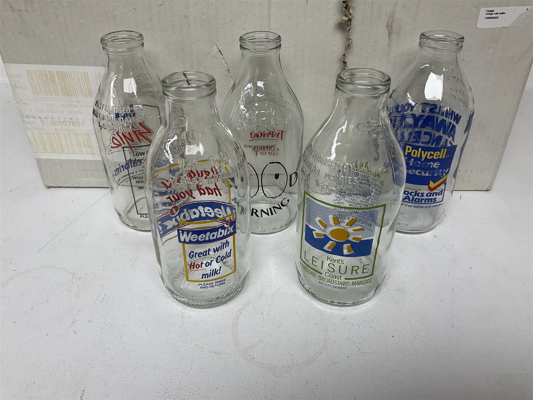 Twenty one vintage advertising milk bottles