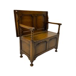 Early 20th century oak Monk's bench, bobbin turned supports with tilting and sliding top/back, hinged box seat, turned feet