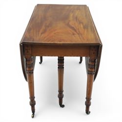 Early 20th century mahogany inlaid oval drop leaf dining table, the crossbanded and line inlaid top with twin hinged leaves (extends to 165cm), plain frieze centred by inlaid panel with stylised star motif, raised on four ring turned tapering supports terminating in brass caps and castors