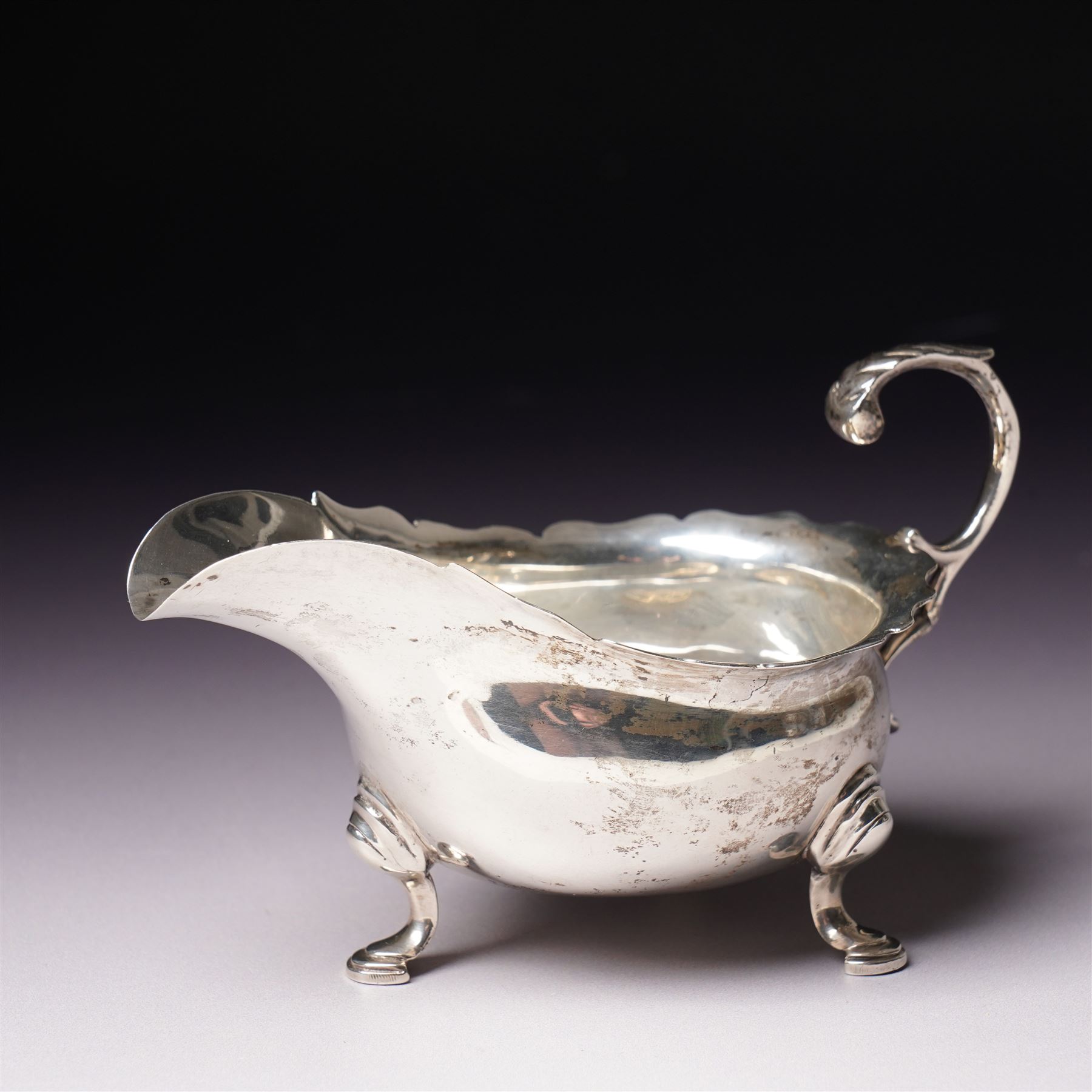 Pair of Victorian silver grape scissors with engraved decoration Birmingham 1860 Maker probably John Gilbert and a small silver sauce boat with crimped rim and C scroll handle Birmingham 1905 Maker Thomas Hayes (2)  