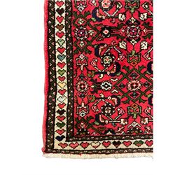 Persian red ground runner, decorated with large Herati motifs and shaped central medallion, the guarded border decorated with repeating heart motifs