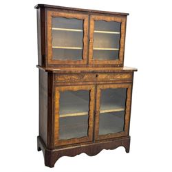 Late 19th century continental display cabinet, the upper section is glazed with twin doors with two upholster shelves, over a lower section with single draw above two glazed cupboard doors on shaped bracket feet