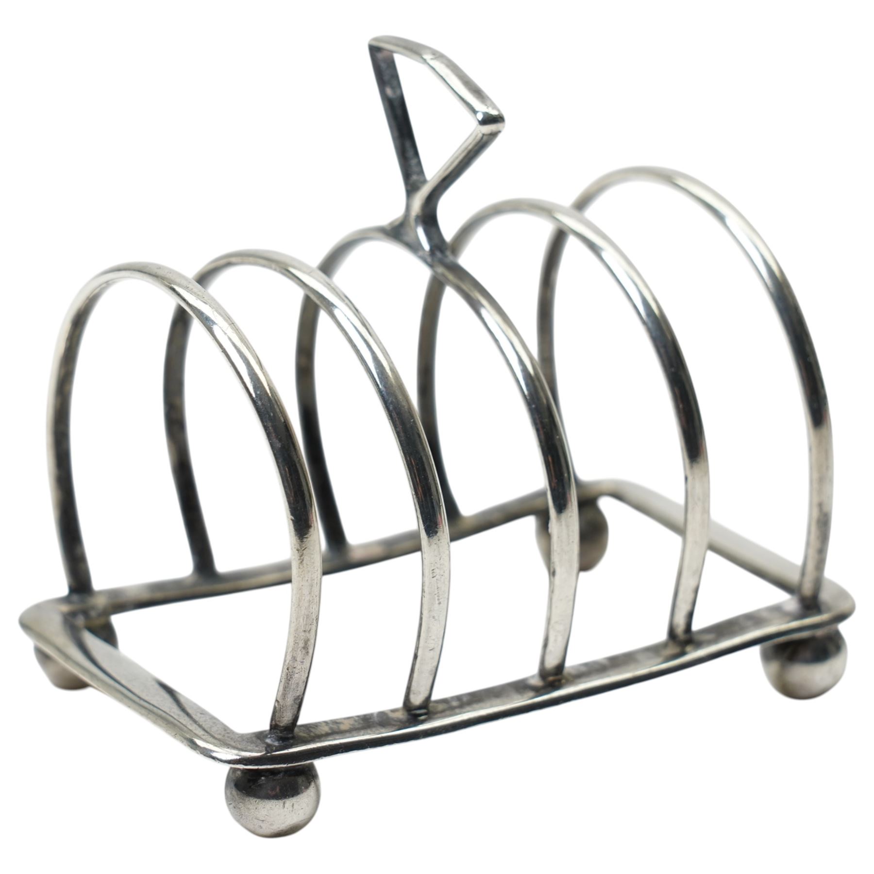 Silver trophy, small silver toast rack and a silver napkin ring
