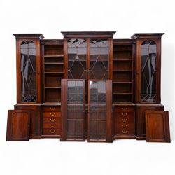 Large Georgian mahogany library bookcase, projecting moulded cornice with row of globular mounts, adjustable shelving enclosed by six astragal glazed doors, fitted with two slides and six panelled cupboard doors, two banks of five drawers, on moulded plinth base; together with two pairs of associated astragal glazed doors in mahogany, from the same property (W55.5cm x H168cm & W48cm x 168cm)
