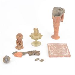 Terracotta figure, seated with hands and feet together with the the handle and spout of a ...