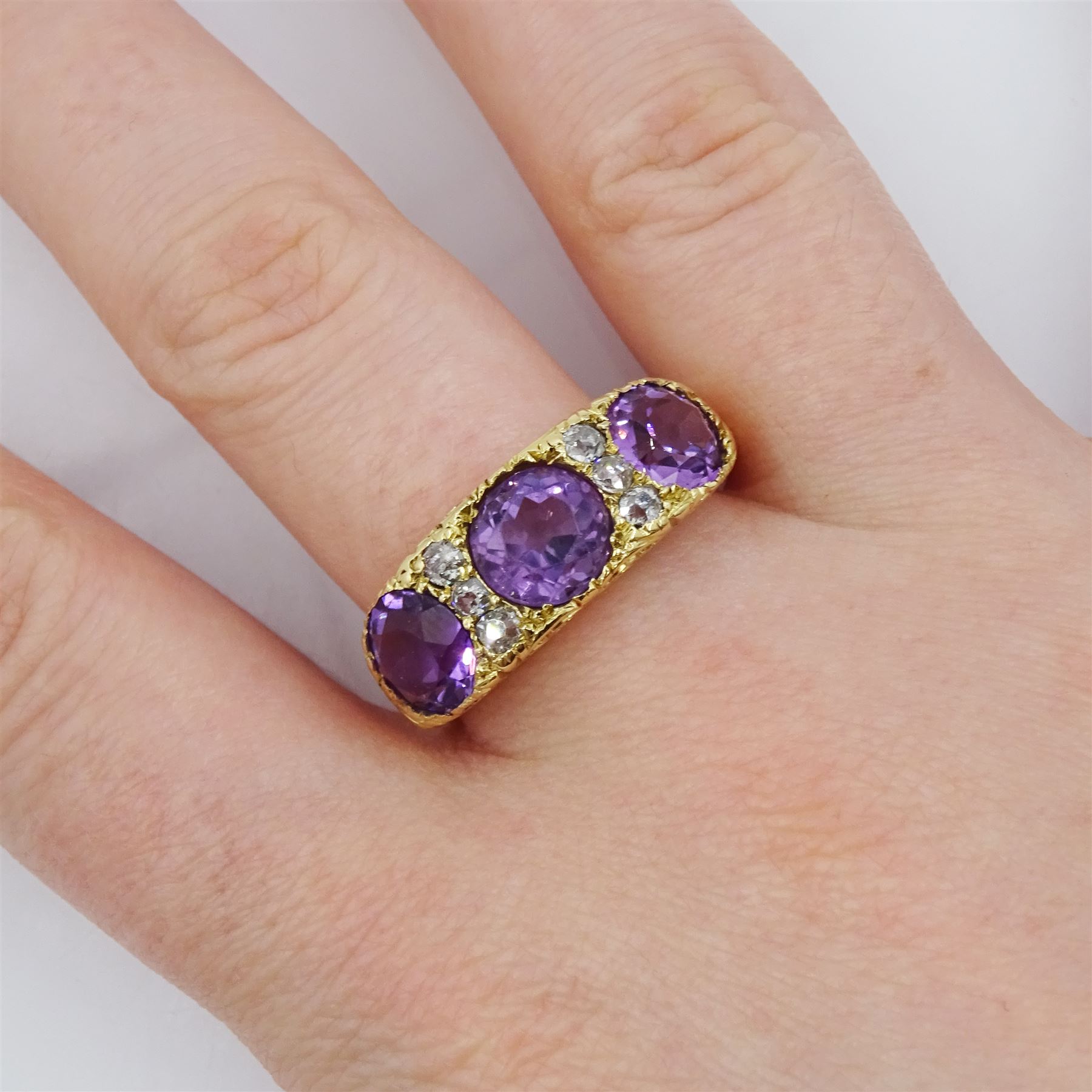 Dutch gold three stone round cut amethyst and six old cut diamond ring, stamped, total amethyst weight approx 3.95 carat