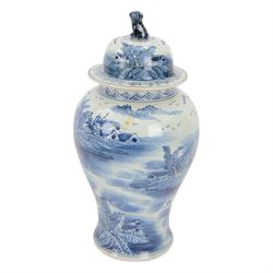 20th century Chinese blue and white jar and cover, of baluster form with domed cover with foo dog finial, decorated with waterside landscape scene with huts upon islands and figures in boats, H45.5cm
