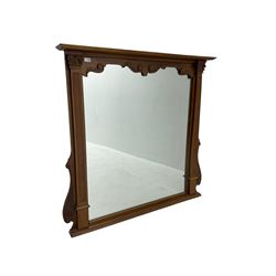 Carved and stained beech overmantle mirror with projecting cornice above square plate, flanked by fluted corinthian column pilasters, with foliage scrolled brackets