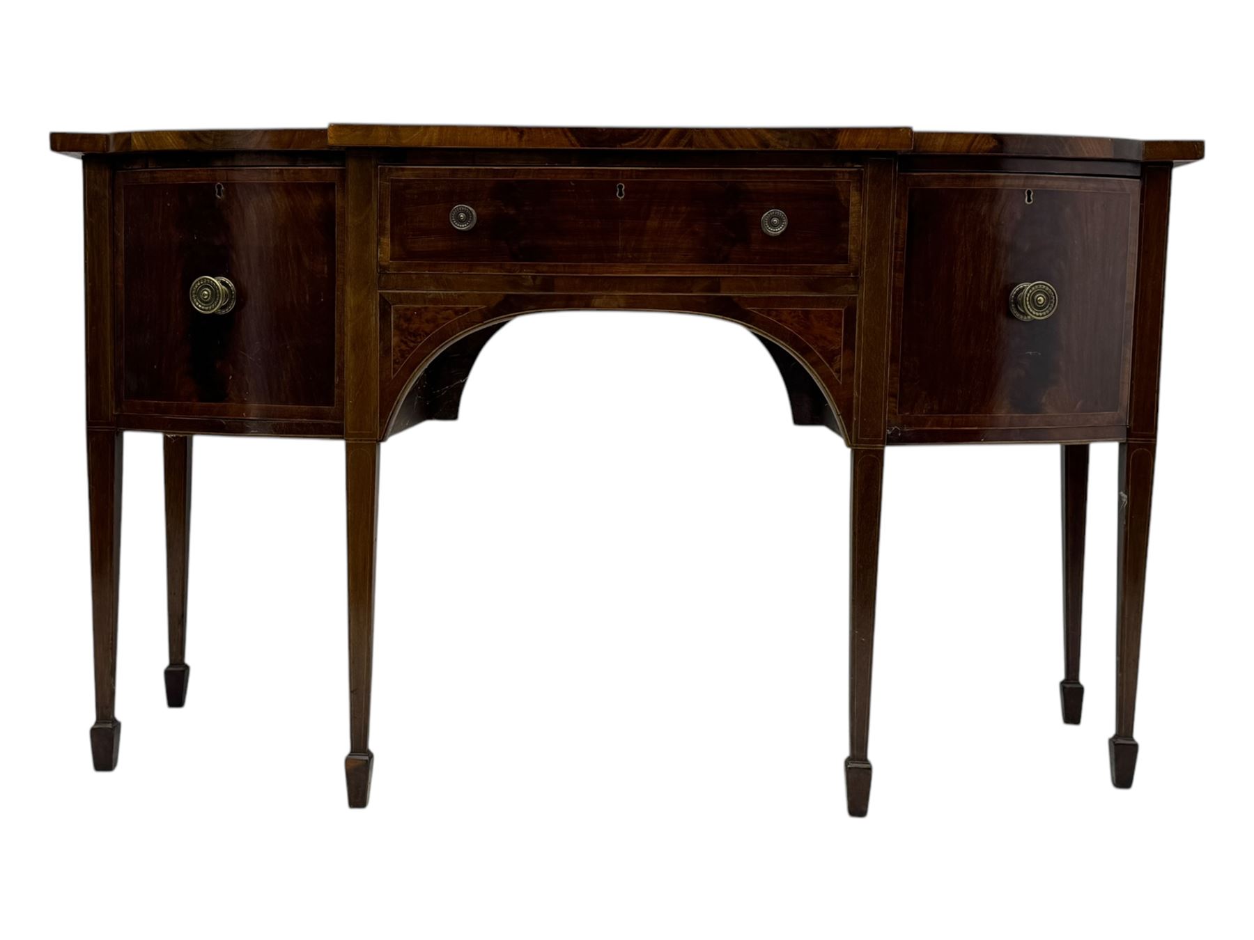 George III mahogany bow-fronted sideboard, serpentine-shaped top with crossbanded and boxwood stringing, over a central drawer flanked by deep cupboards, on square tapering supports terminating in spade feet