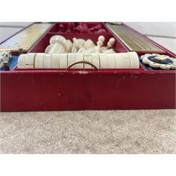 19th century walnut and brass bound games compendium box, painted to enhance the grain, of rectangular form, the hinged opening cover with rounded sides, central brass cartouche with engraved lion crest, and brass riveted straps, opening to reveal a red leather and blue silk lined compartmented interior, with fold-down games board, and lift-out tray containing playing cards, ebony turned dice towers, white and red stained bone draughts, and chess pieces, ivory dice, and ivory and ebony whist markers, and brass bezique board, cribbage board and markers, H15cm W32cm D24cm
This lot has been registered for sale under Section 10 of the APHA Ivory Act