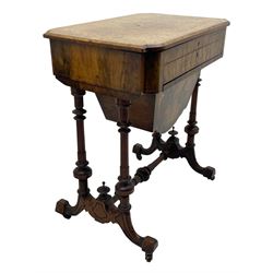 Victorian figured walnut lady's sewing or writing table, canted and curved rectangular form, the figured top enclosing pen rest with ink bottle divisions and adjustable hinged writing surface with leather inset, the frieze drawer fitted with various compartments, sliding storage well beneath, inlaid throughout with foliate motifs in boxwood, quadruple turned pillar supports on splayed feet with block terminals, united by turned stretcher 