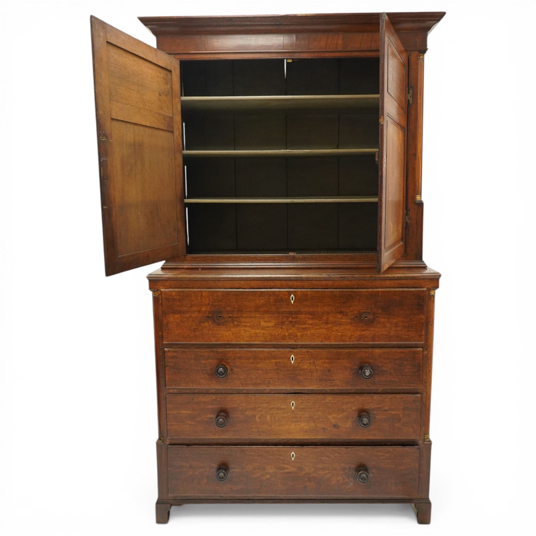 George III oak and mahogany bound enclosed bookcase-secretaire, panelled cupboards over four drawers