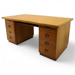 Mid 20th century teak twin pedestal partners desk, rectangular top with rounded corners with integral frieze storage shelf, above  pedestals each fitted with three drawers, recessed circular pull handles, cupboard doors fitted to the opposing side on concealed plinth bases