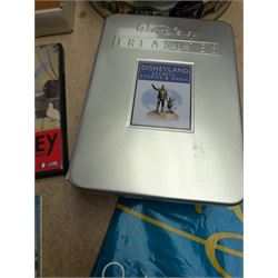 Collection of Disney memorabilia and ephemera, including Walt Disney Treasures DVD, two Disney Villains mugs, enamel pins, Mickey Mouse D23 fan club pack, Disney Twenty-Three magazines, Sketches magazines, etc