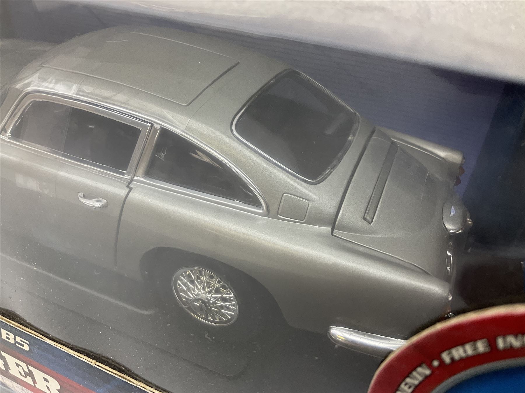  Three RCERTL Joyride James Bond 1:18th scale die-cast model cars - 1965 Aston Martin DB5 from Goldfinger, Lotus Esprit from The Spy Who Loved Me and Aston Martin DB5 from Casino Royale, all boxed (3)