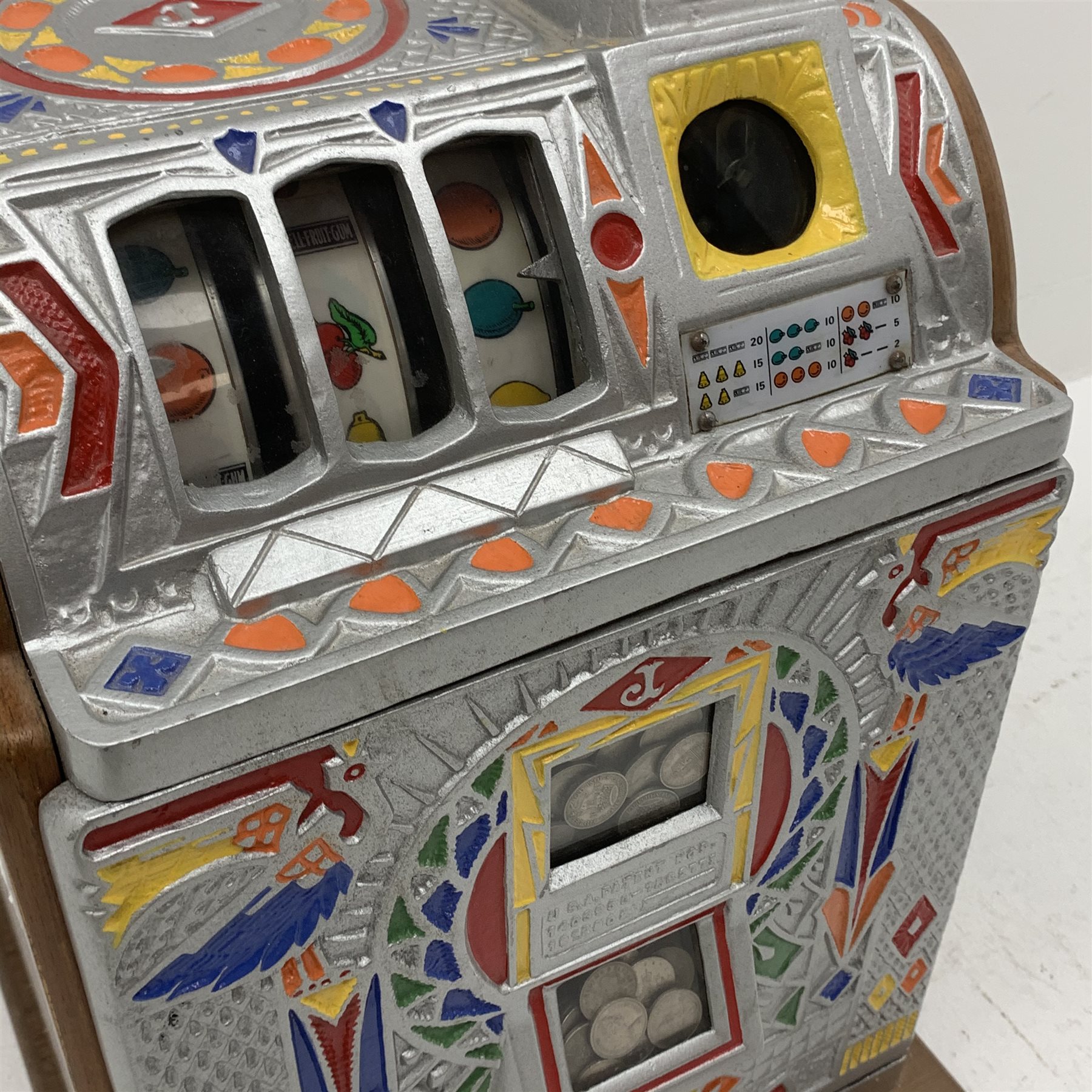 A one arm bandit fruit slot machine, the oak case with cast metal front and top with polychrome detail, with jackpot windows and single pull arm, patent no to front, H62cm. 