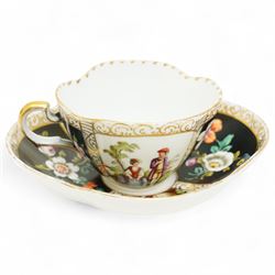 Helena Wolfsohn Dresden porcelain quatrefoil teacup and saucer, decorated with panels of figures and floral sprays on a black ground, marked to base, together with a flask with painted scene of travellers in a port, indistinct continental mark to base, flask H12cm