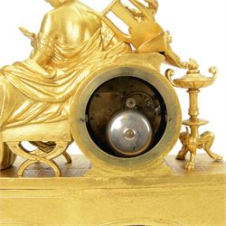 French- Napoleon III porcelain inset 8-day figural clock in a gilt case c1870, drum housed movement resting on a rectangular plinth with light blue porcelain panels each painted with different classical images and depictions from antiquity, conforming dial with a garland of flowers to the centre, gilt Roman numerals, minute track and brass spade hands, with a seated figure of a classical maiden reading a book, mounted on a matching gesso base with a velvet padded top, Parisian countwheel striking twin train movement, striking the hours and half hours on a bell. With a contemporary ebonised base and oval glass dome. With pendulum.
