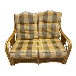 Two seat bamboo and cane conservatory sofa, and pair of matching armchairs with footstool and cane nest of tables 