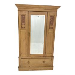 Victorian pine wardrobe, single mirror door and drawer to base, the panelled front carved with floral planters