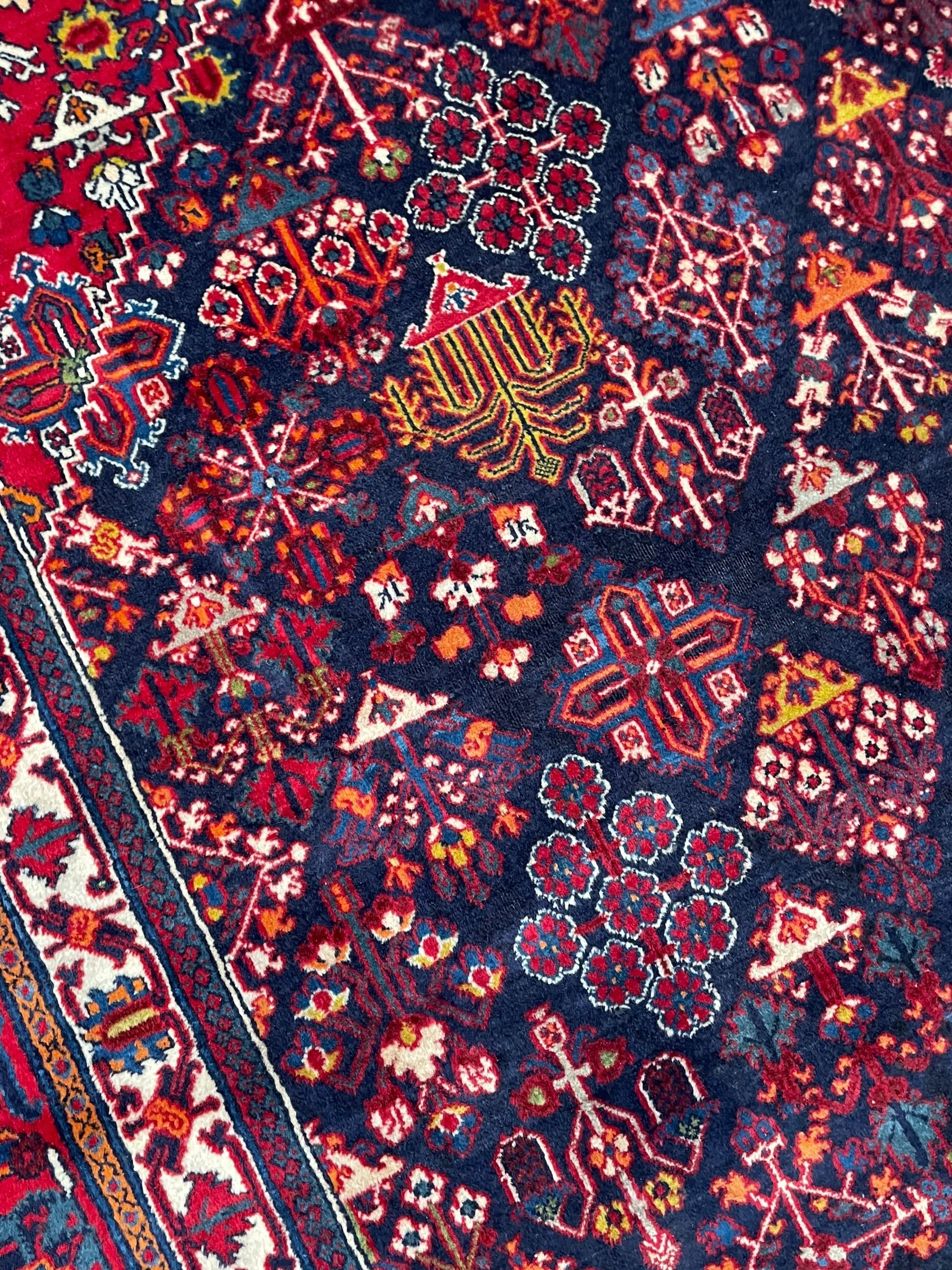 Persian Meimeh indigo ground rug, the central medallion within a field of small floral lozenge motifs, the guarded border with repeating pattern